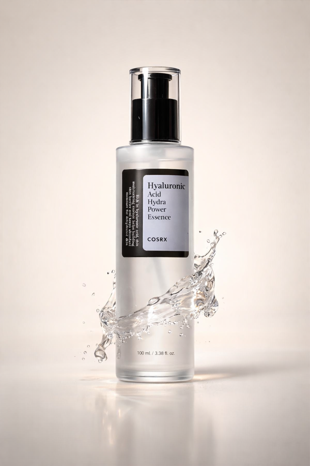 COSRX Hyaluronic Acid Hydra Power Essence 100ml in clear pump bottle with water splash background